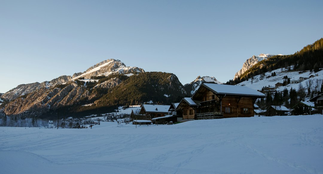 Chalets en bois sous la neige face aux sommets
